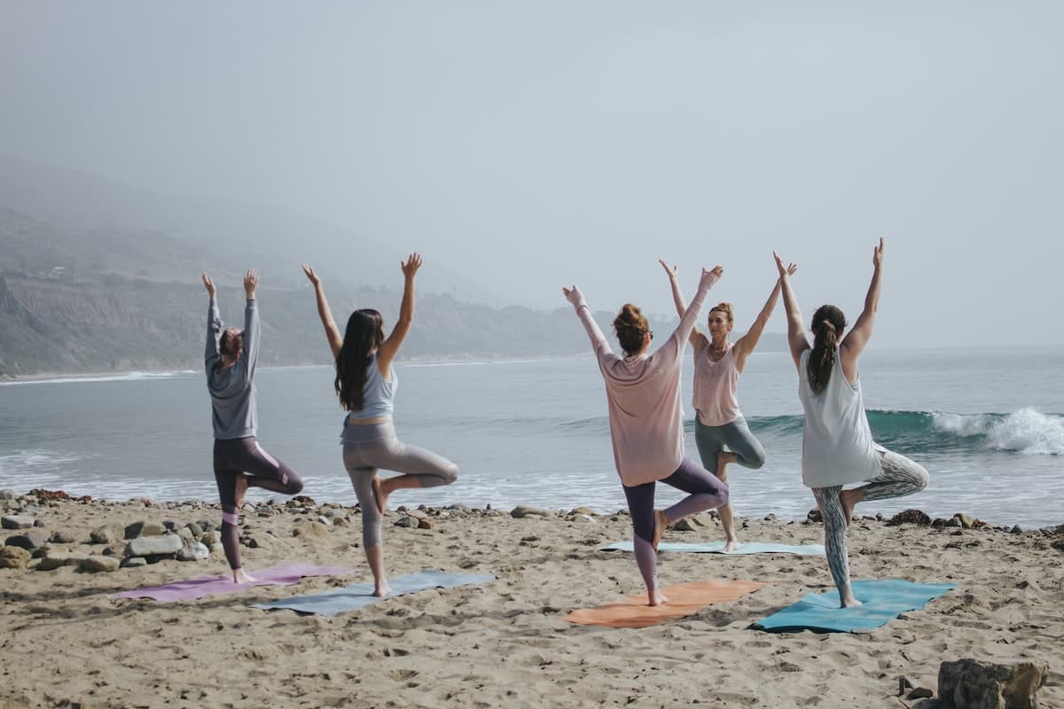 A teacher demonstrating a posture for a small training cohort.